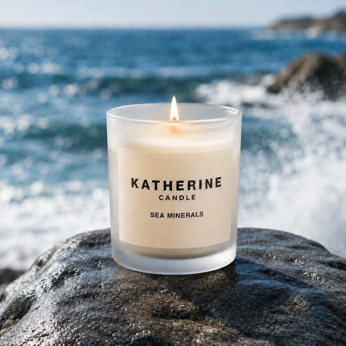 Sea minerals coconut soy wax candle in frosted glass jar, flame lit on stone