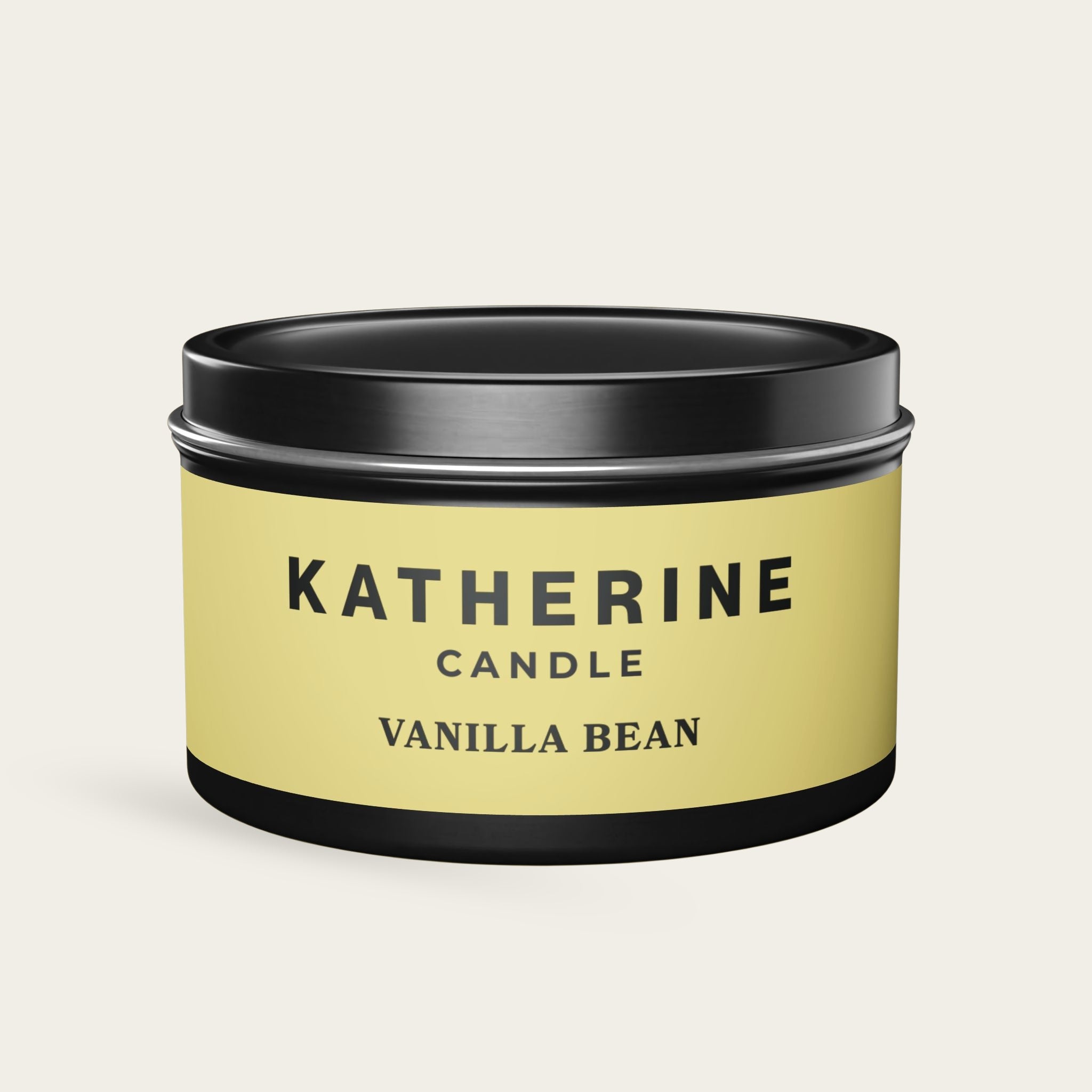 Vanilla Bean candle jar with black lid and base, yellow label with KATHERINE CANDLE.