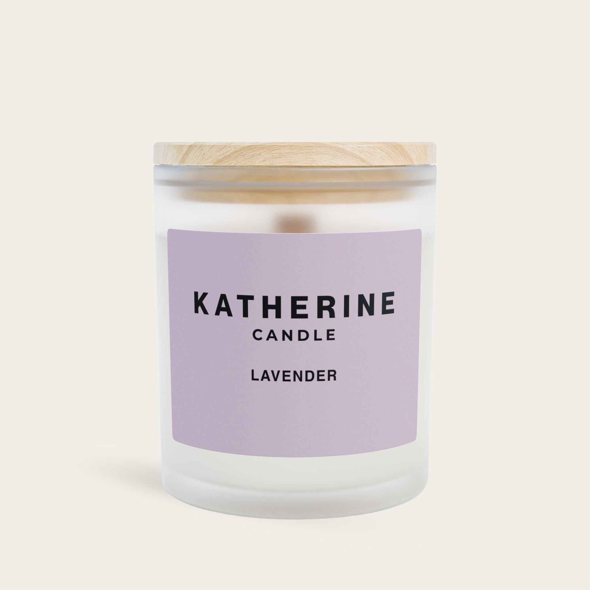Lavender candle in clear glass jar with white lid, purple label