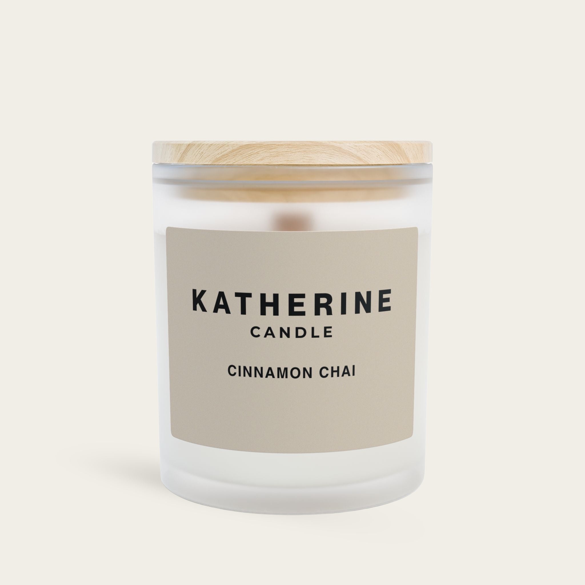 Cinnamon Chai candle in frosted glass jar with wood lid and KATHERINE CANDLE label