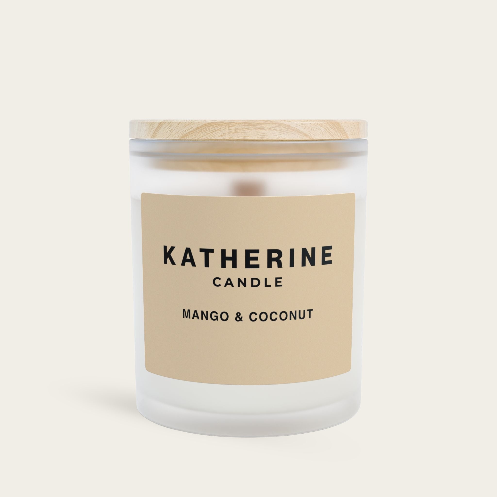 Scented candle jar with beige label and white wax lid, Mango & Coconut scent.