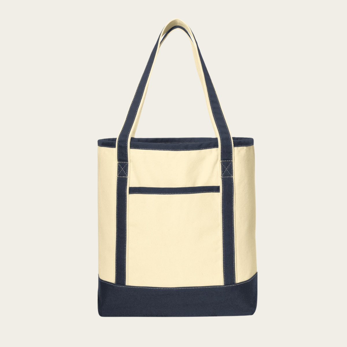 Large cotton canvas tote with cream body, navy handles, base, trim, and front pocket