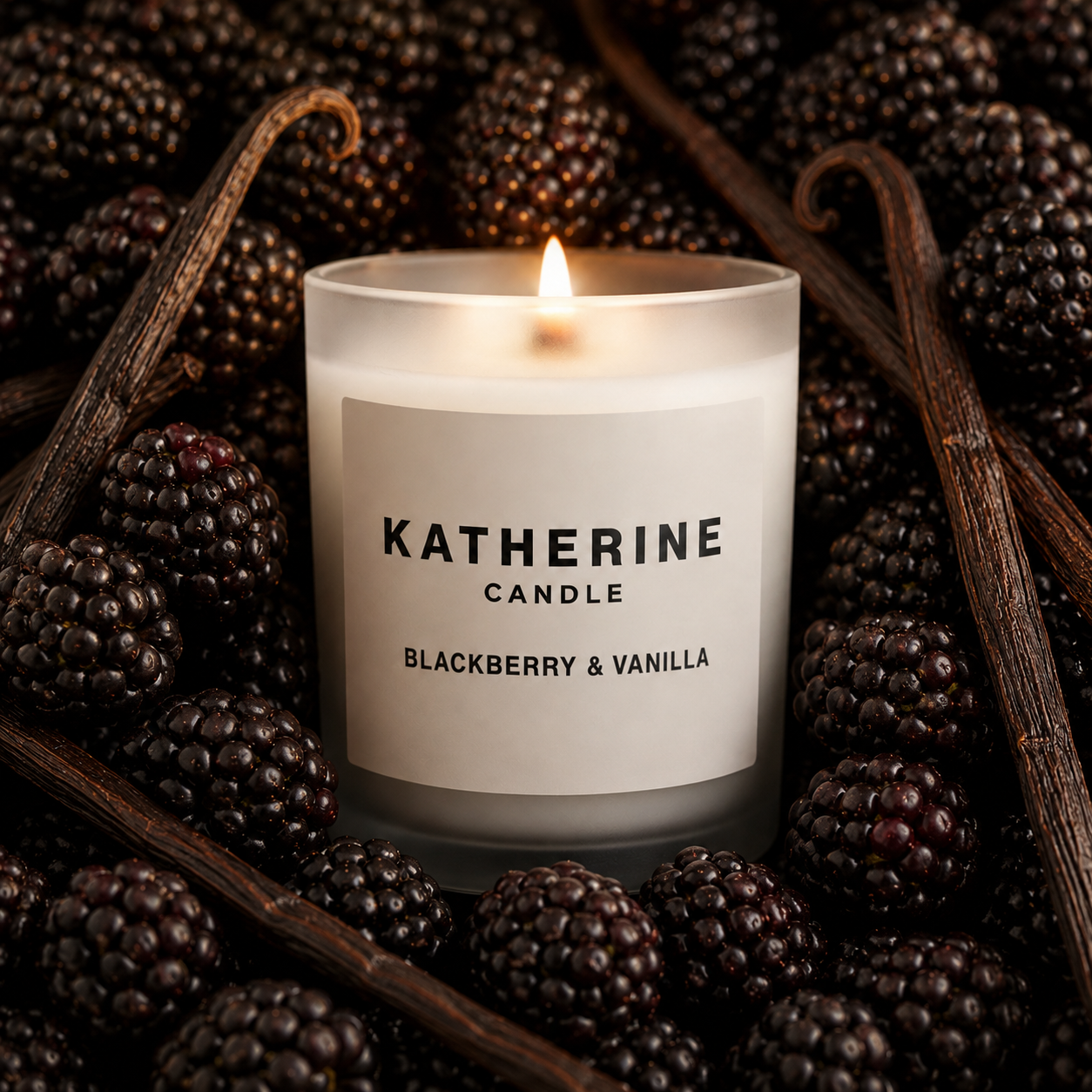 Scented candle in white jar with lit flame and KATHERINE label, blackberry & vanilla