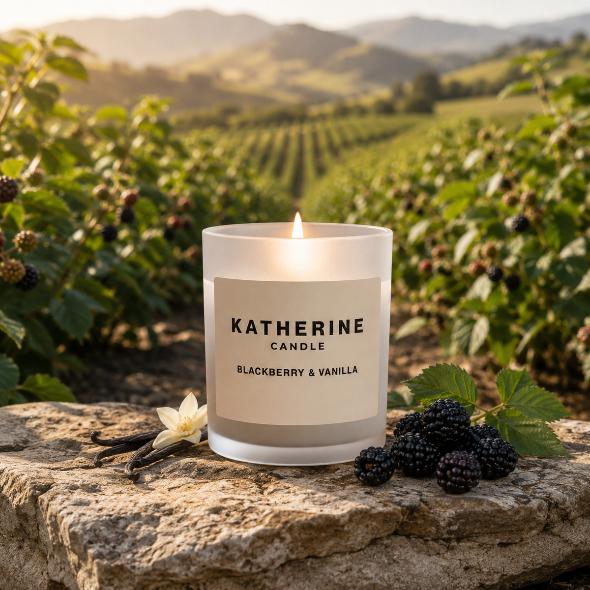 White candle jar with lit wick, KATHERINE "Blackberry & Vanilla" label