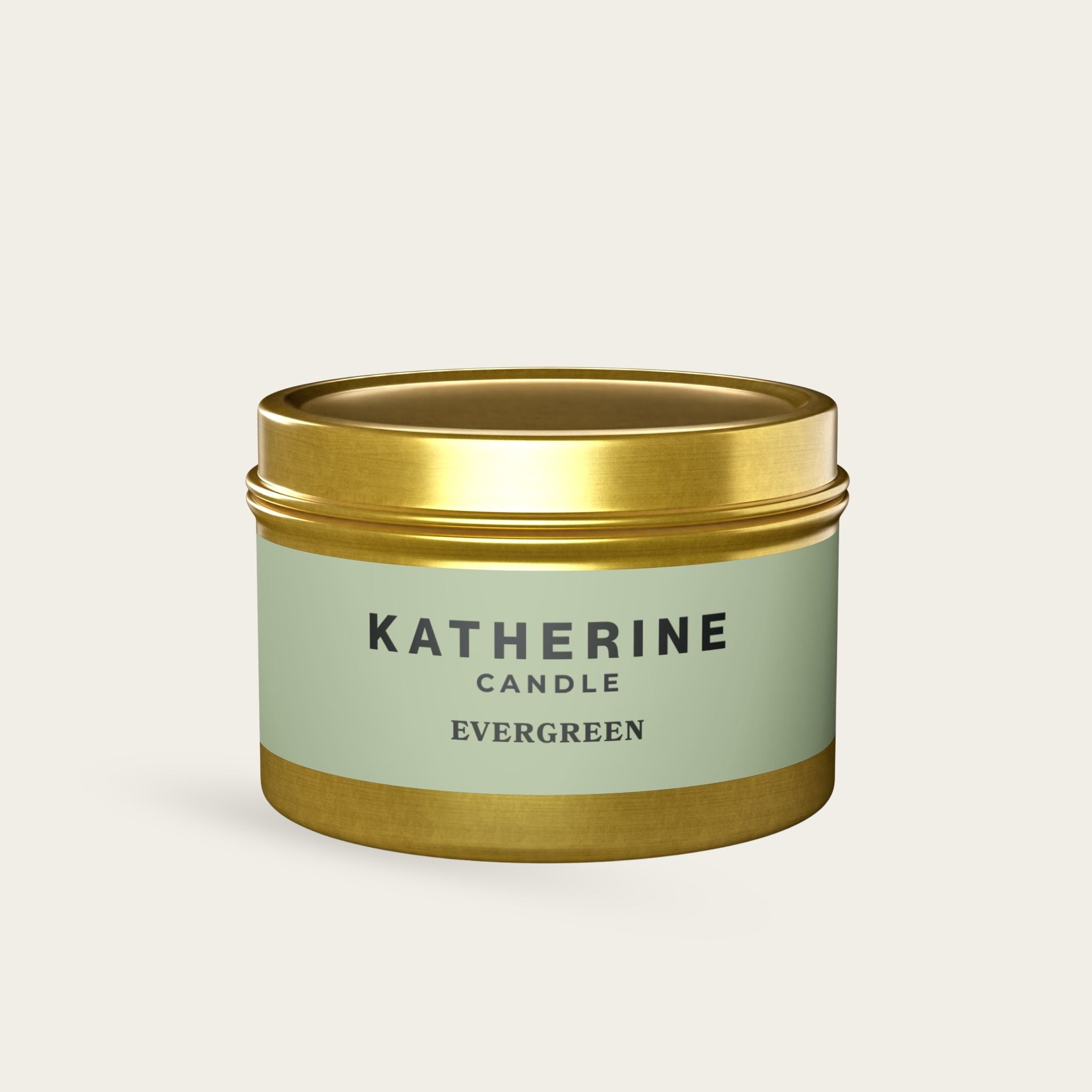 Evergreen candle in gold metal tin with green label and KATHERINE CANDLE lettering