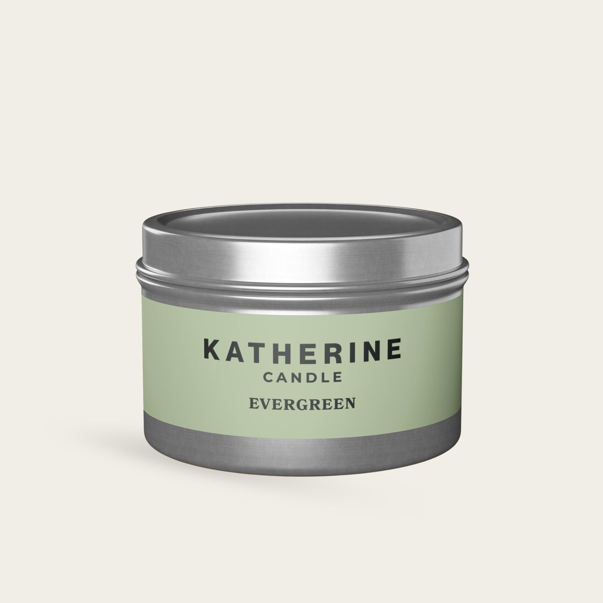 Evergreen candle in silver metal tin with green label and KATHERINE CANDLE text