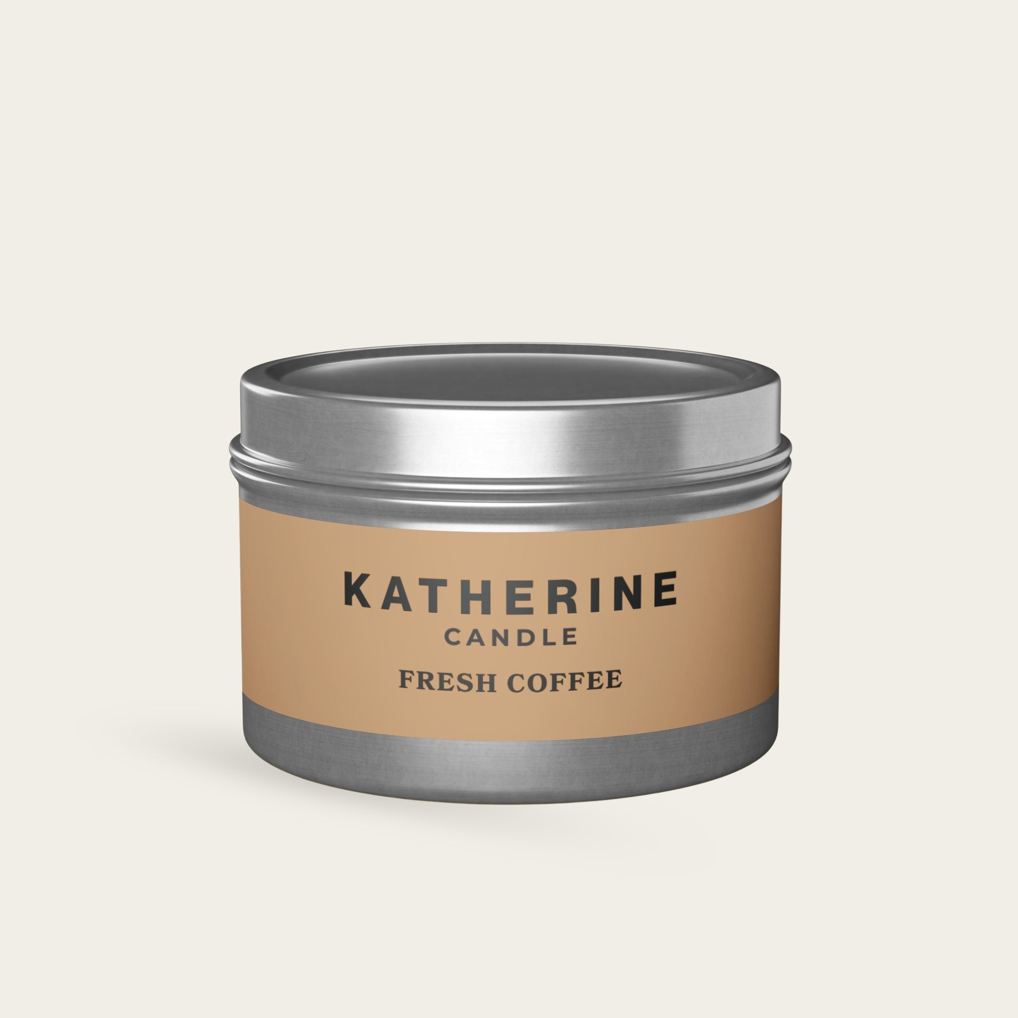 Silver-lidded candle jar with beige label and dark base reading KATHERINE FRESH COFFEE