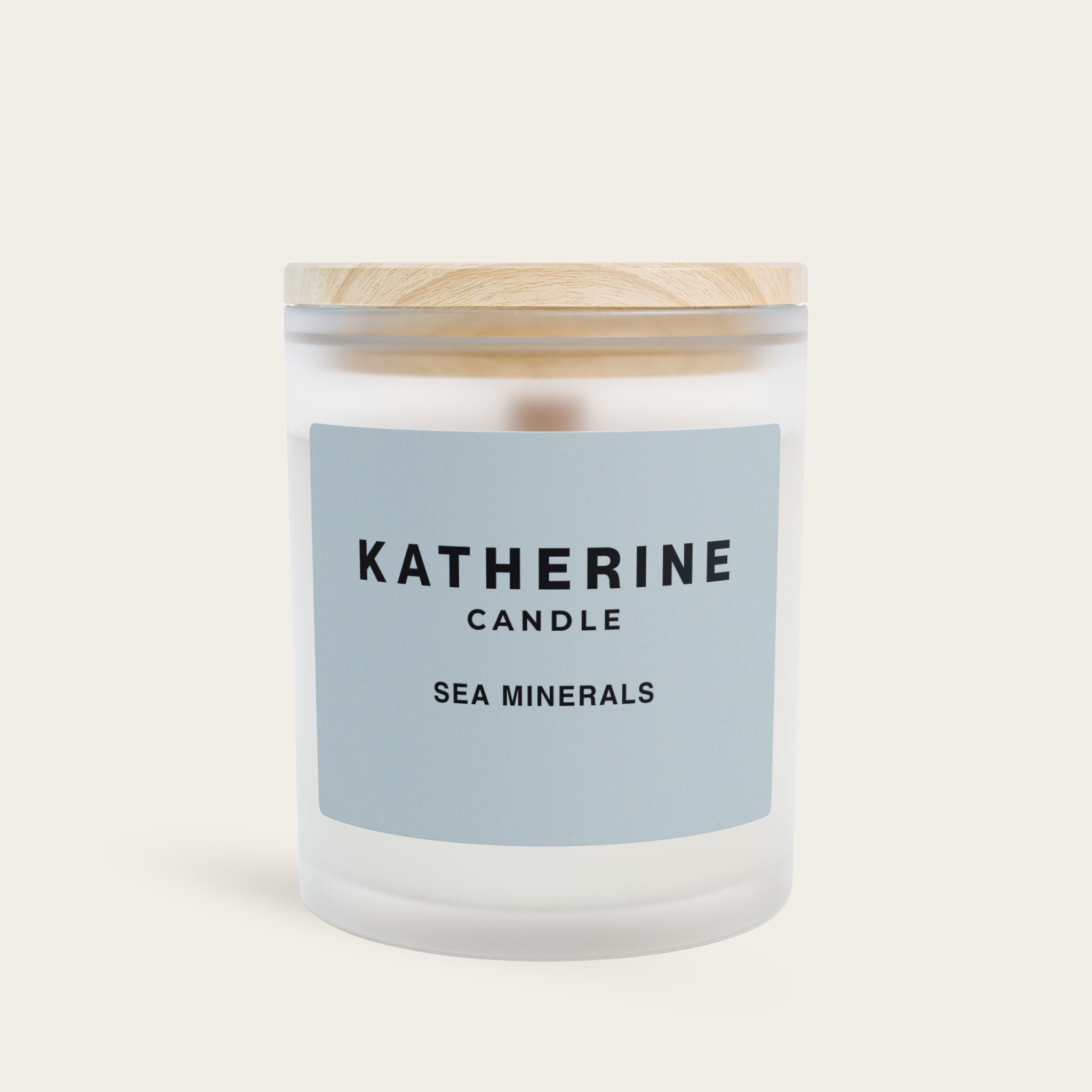 Sea Minerals candle in frosted glass jar with blue label and wooden lid