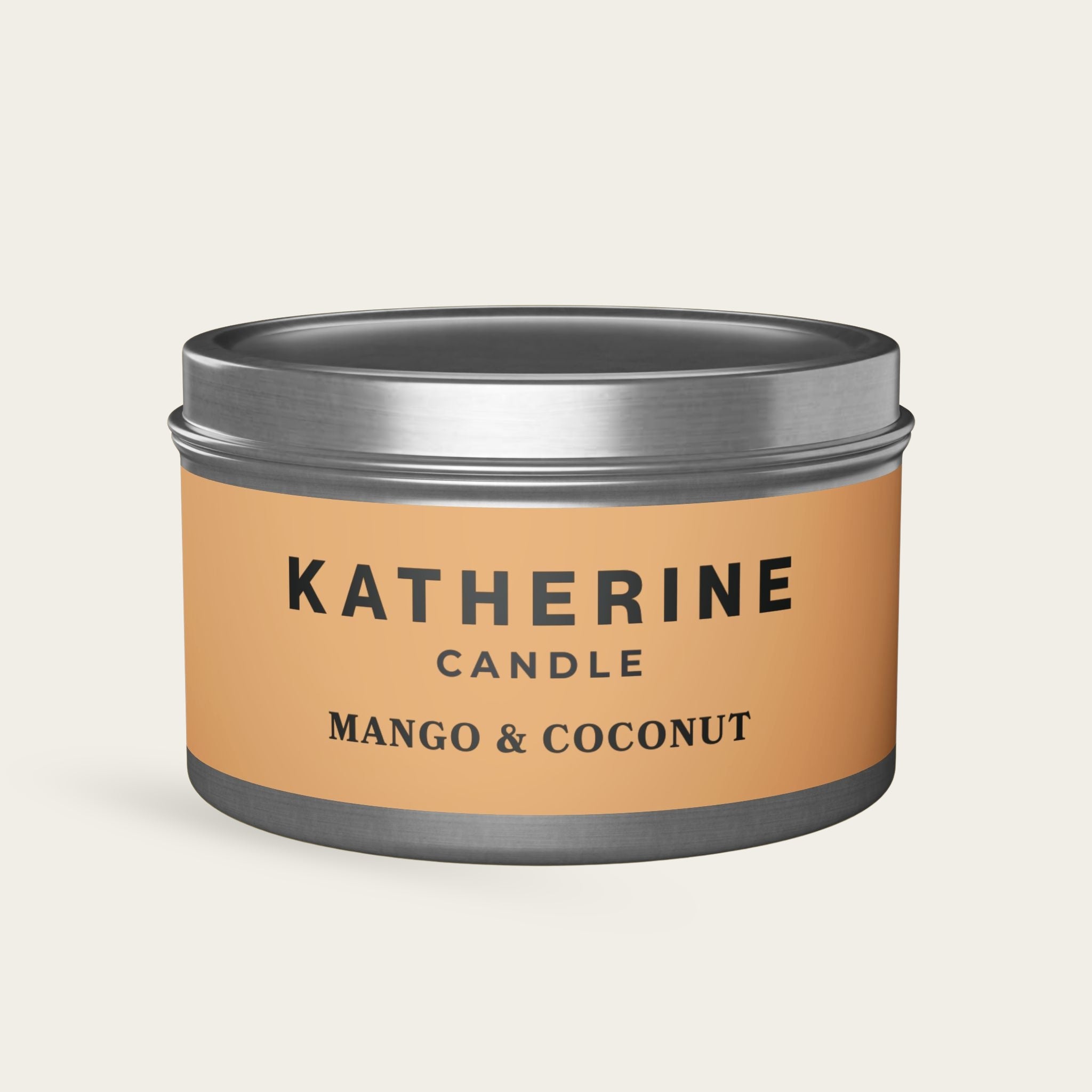 Silver-lidded candle jar with dark gray jar and Mango & Coconut label