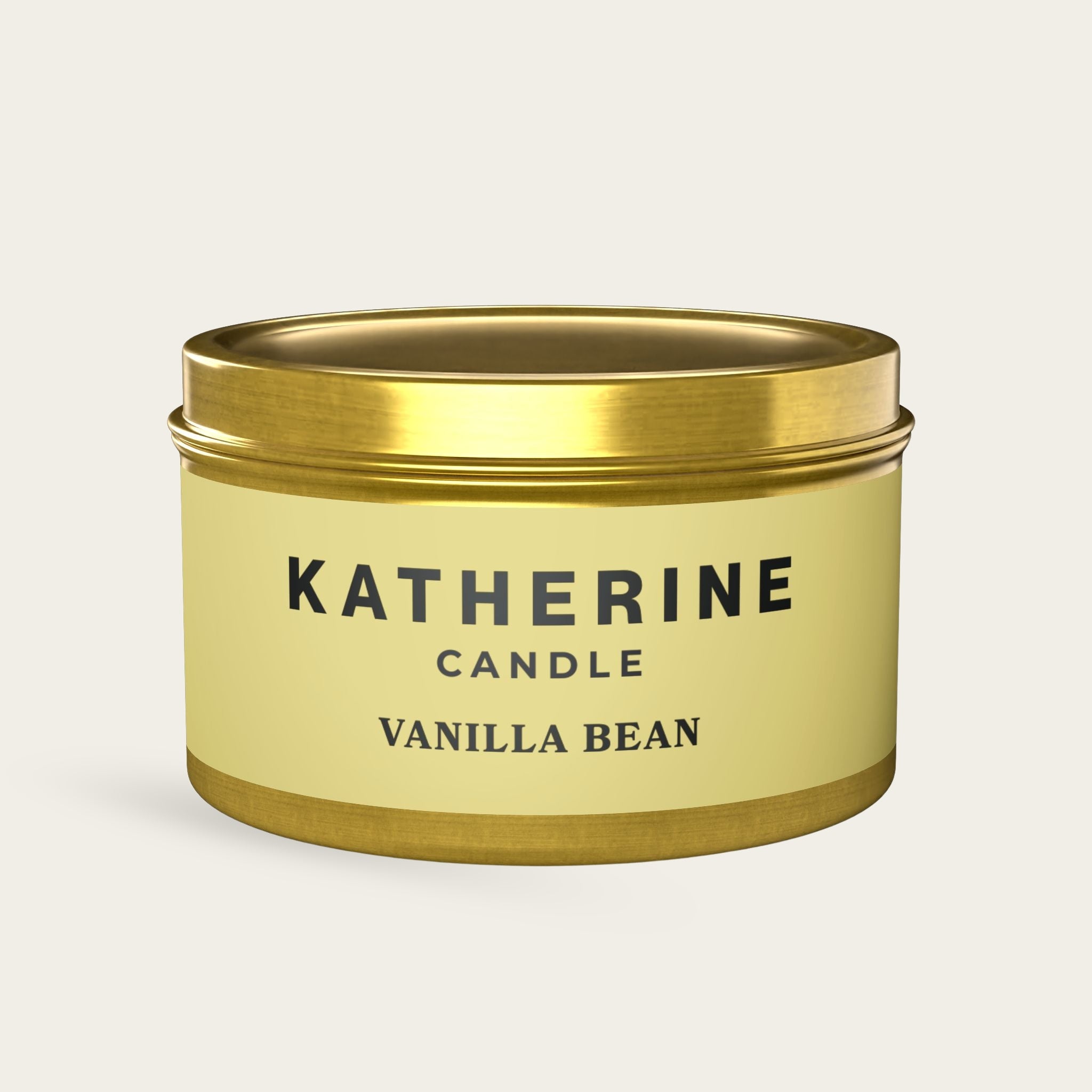 Vanilla Bean candle jar with gold lid and base, beige label with KATHERINE CANDLE.
