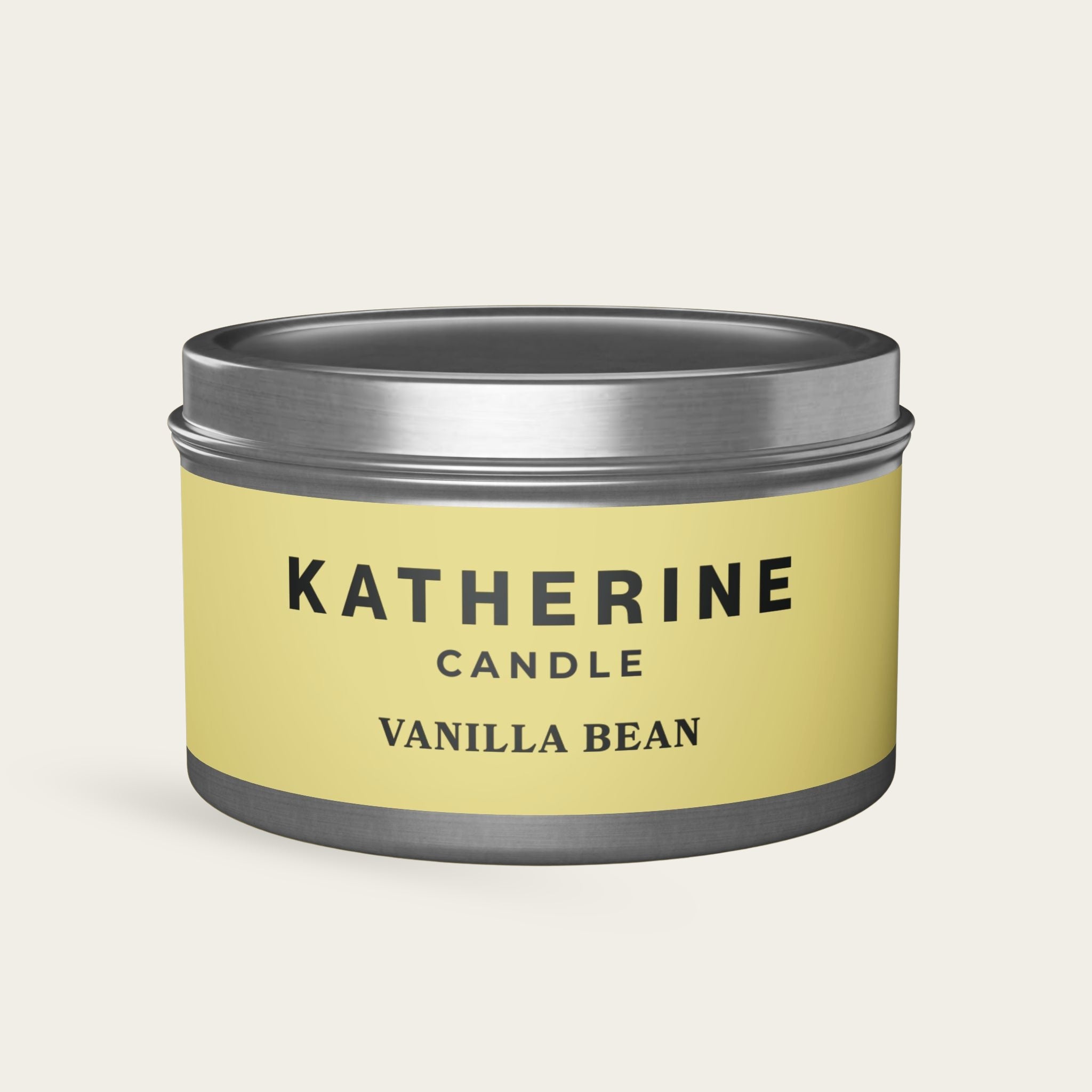 Vanilla Bean candle jar with silver-gray lid and base, yellow label with KATHERINE CANDLE.