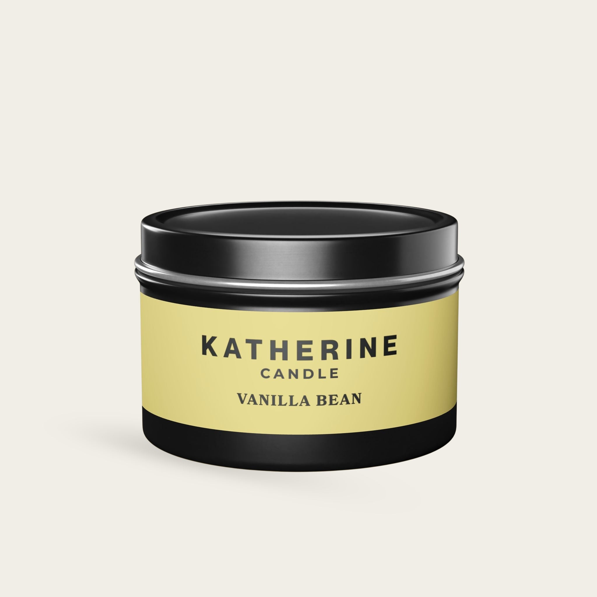 Vanilla Bean candle jar with black lid and base, yellow label with KATHERINE.