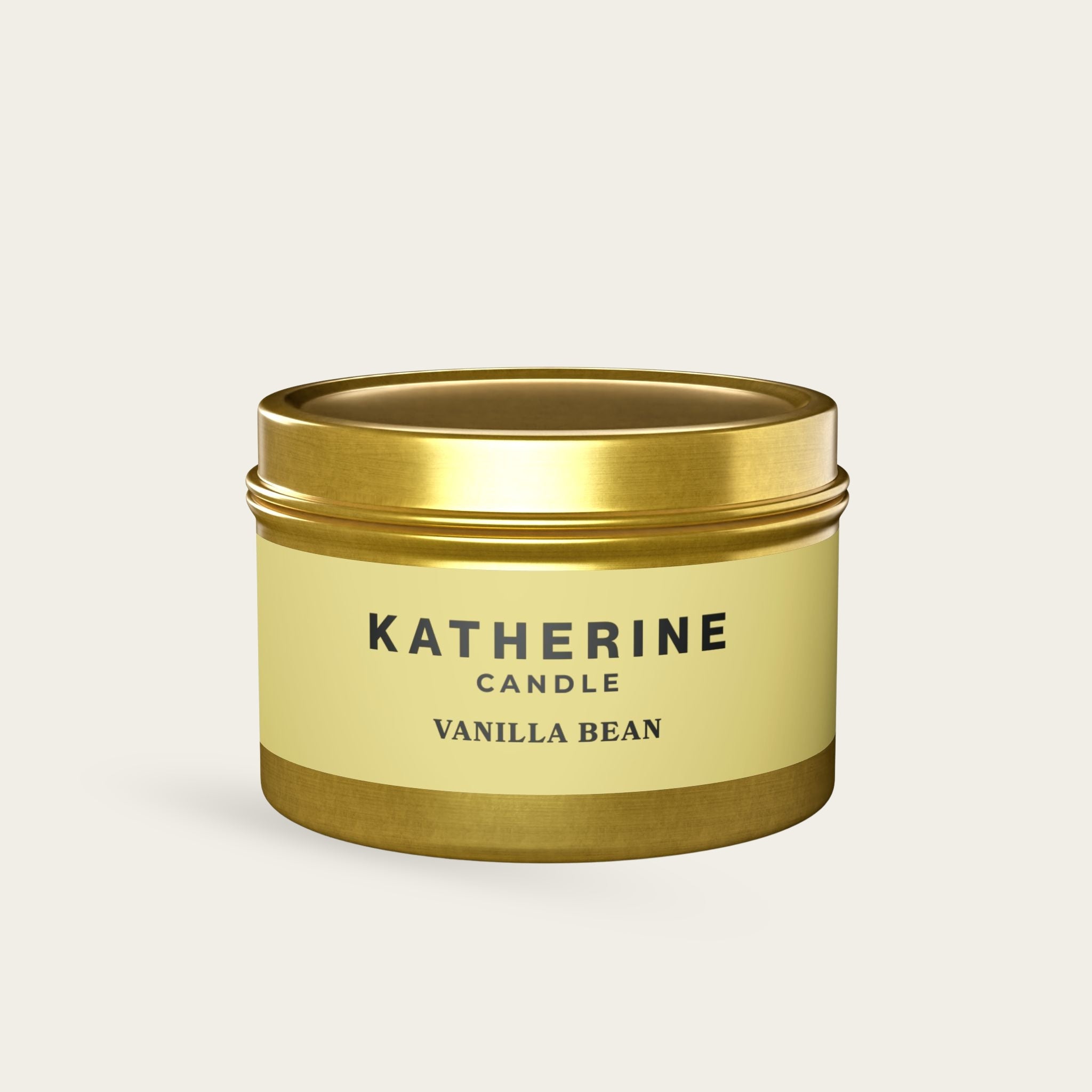 Vanilla Bean candle jar with gold lid and base, beige label with KATHERINE.