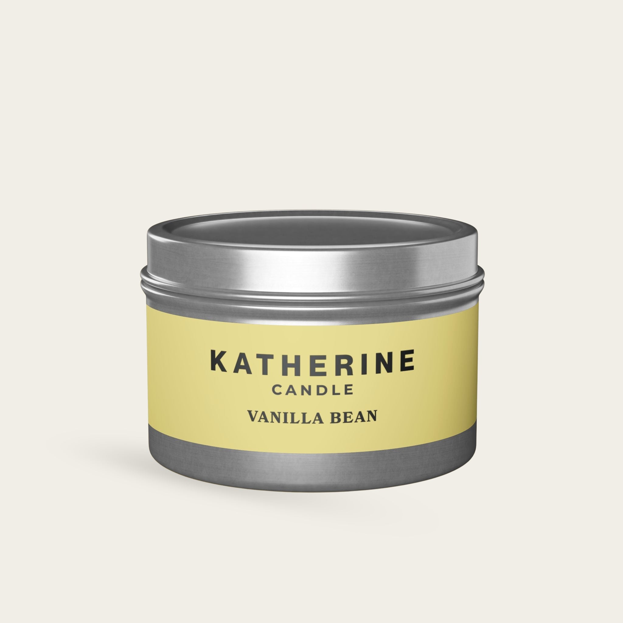 Vanilla Bean candle jar with silver-gray lid and base, yellow label with KATHERINE.