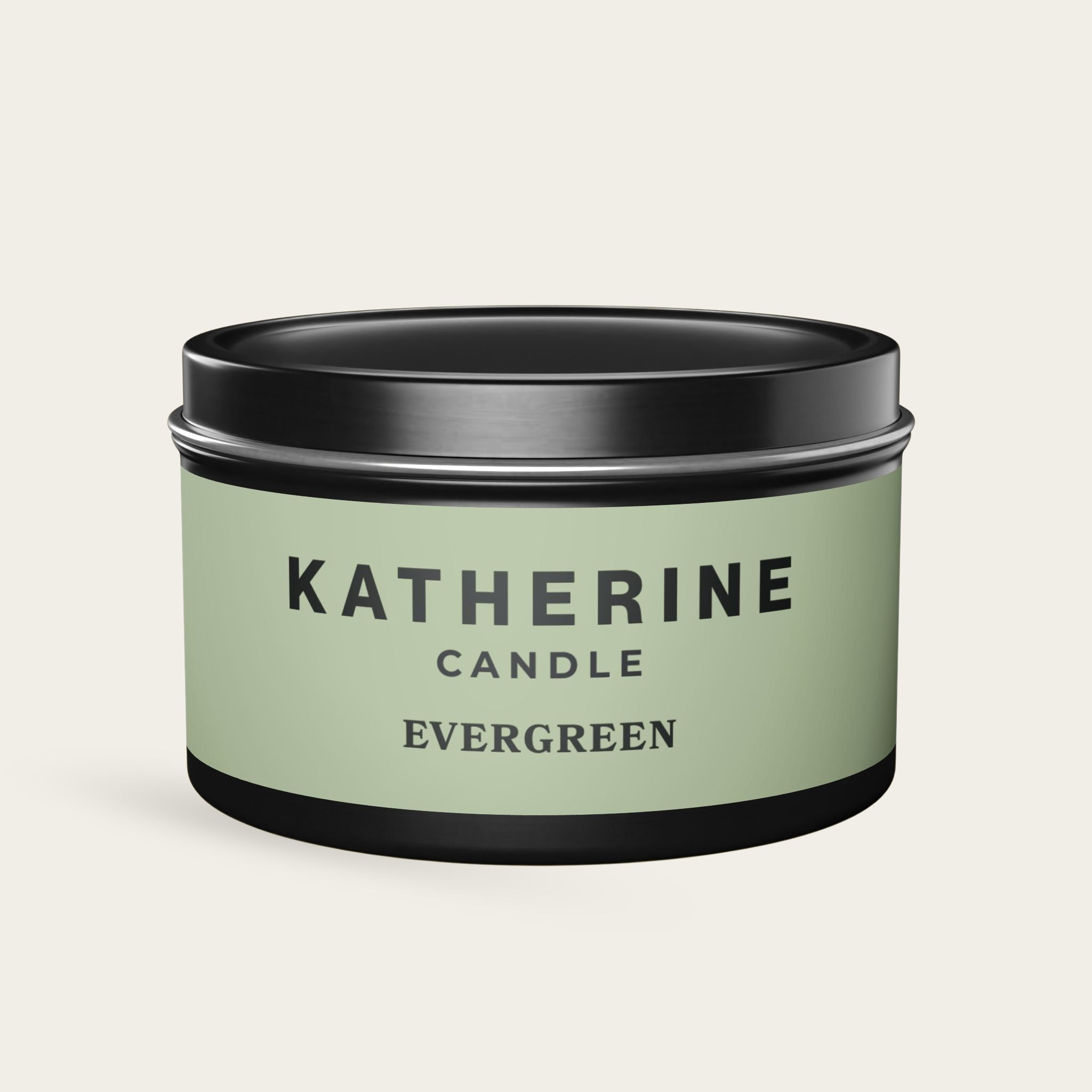 Evergreen candle in black metal tin with green label, KATHERINE CANDLE and EVERGREEN