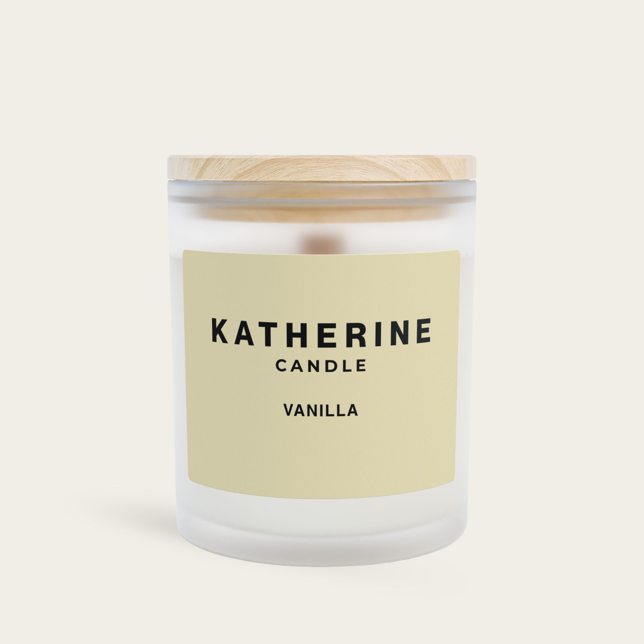 Vanilla candle in frosted white glass jar with KATHERINE CANDLE vanilla label