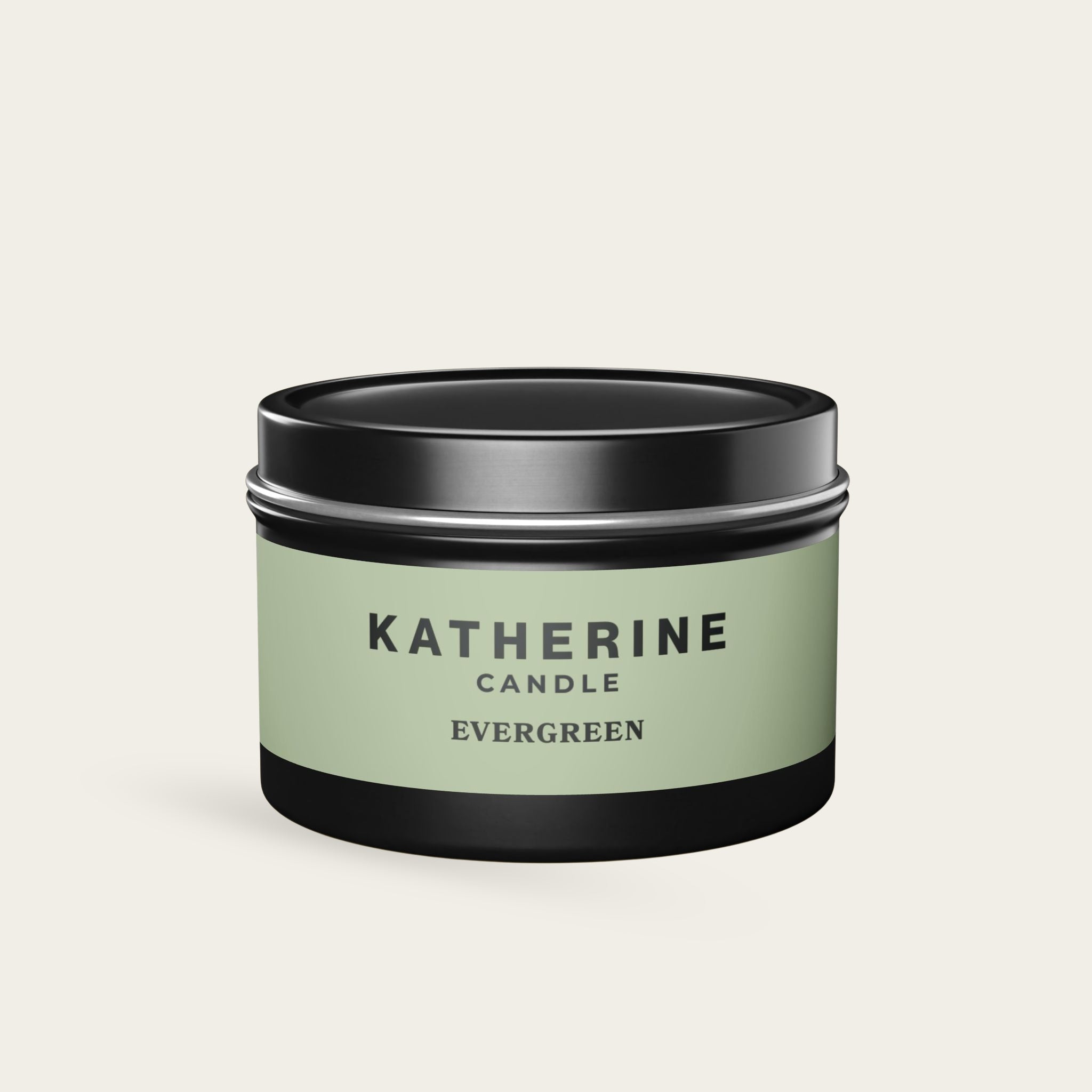 Evergreen candle in black metal tin with green label and KATHERINE CANDLE text